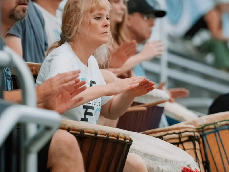 Supporters drumming and clapping in the stands