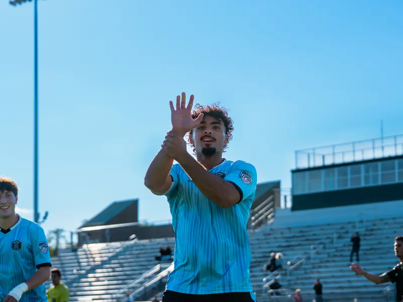 A Detroit Metro FC player applauds the crowd