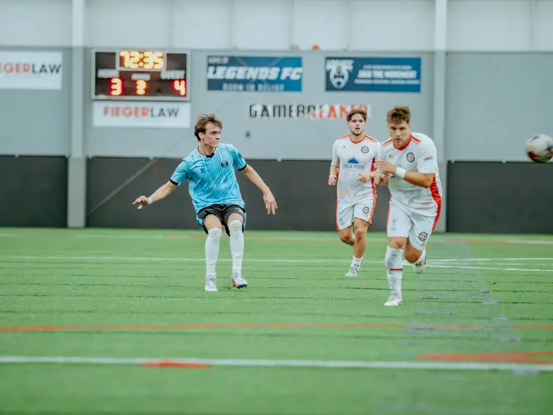 A Detroit Metro FC player brings the ball forward