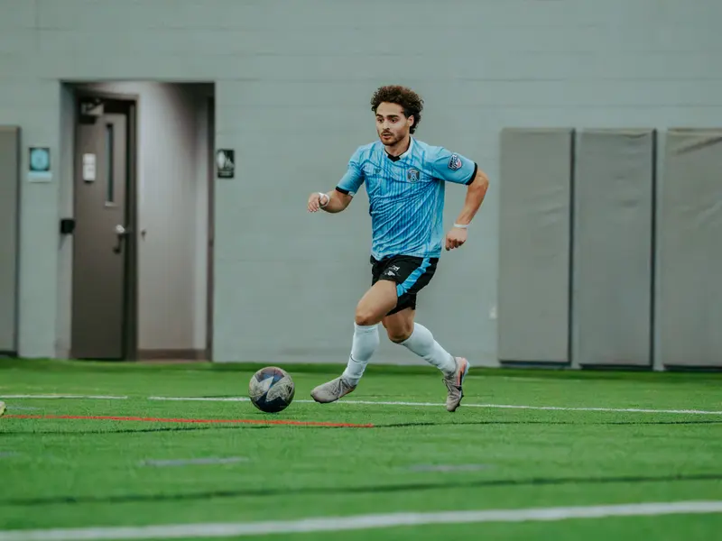 A Detroit Metro FC player dribbles at Legacy Center