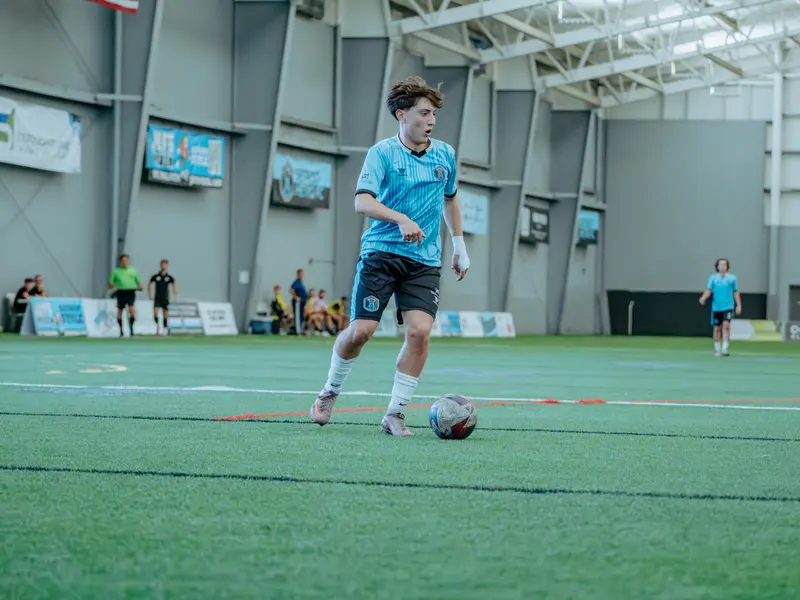 A Detroit Metro FC player on the ball in midfield